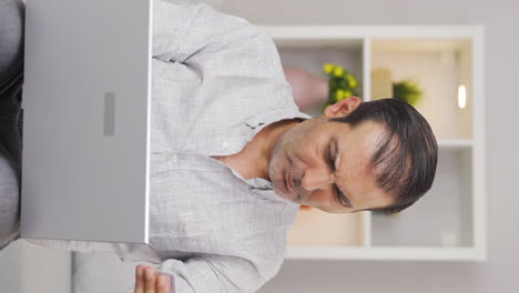 Vertical-video-of-Man-shopping-from-laptop.